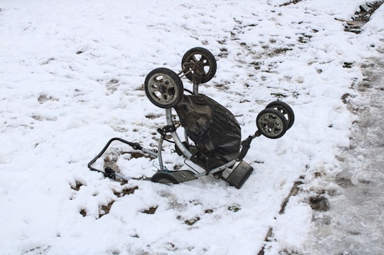 a broken down bicycle sitting in the snow