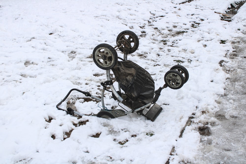 a broken down bicycle sitting in the snow