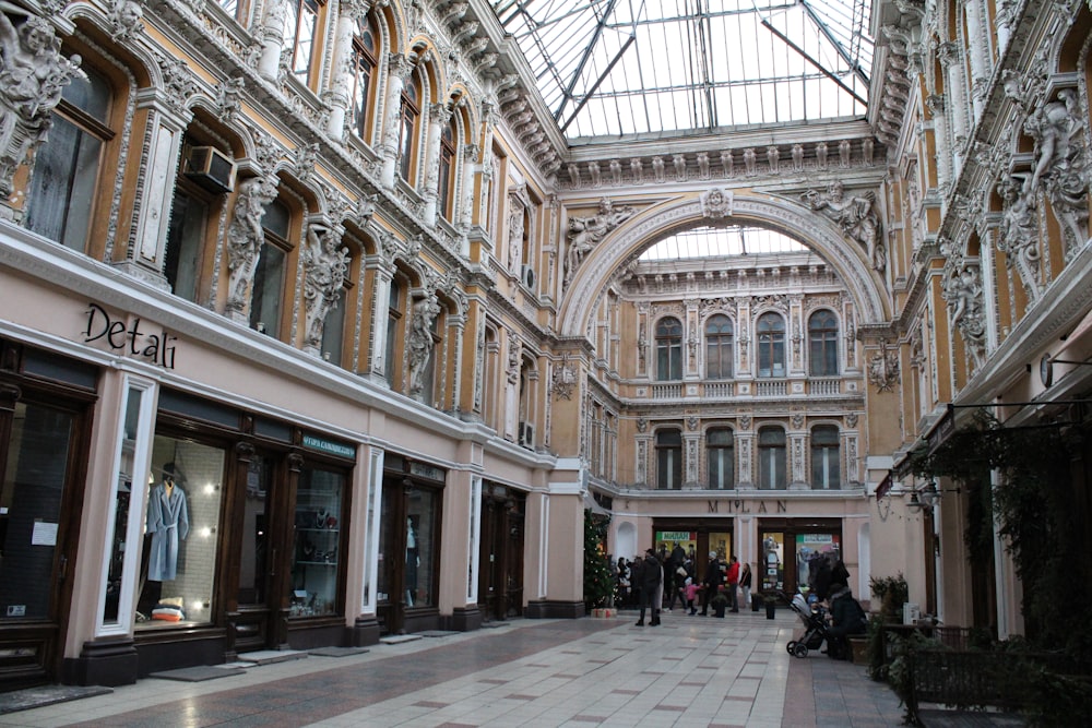 a group of people walking inside of a building