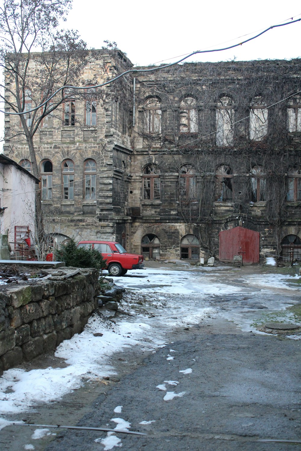 a red truck parked in front of an old building