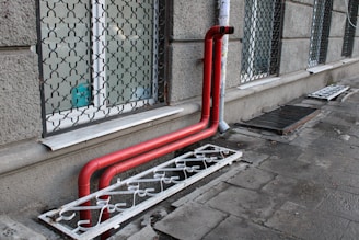 a red pipe on the side of a building