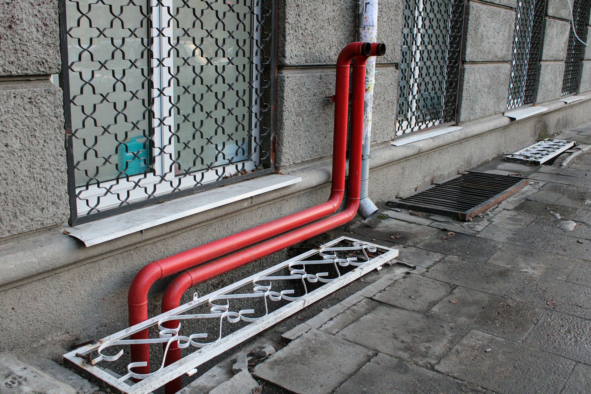 a red pipe on the side of a building