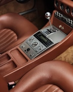 a car dashboard with a radio and a remote control