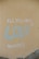 Graffiti on a beige wall with the words 'ALL YOU NEED IS LOVE BACKERS!' written in white and blue paint. The word 'LOVE' is written in blue with artistic, swirly lines.