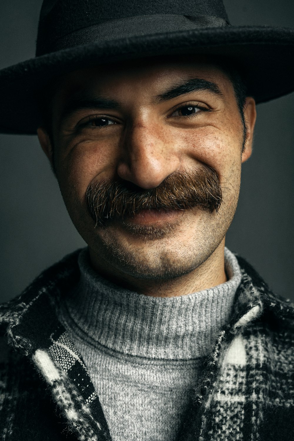 a man with a mustache and a hat