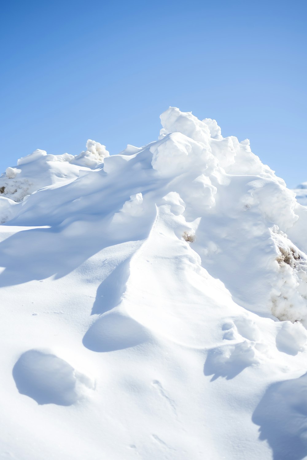 a man riding skis down a snow covered slope