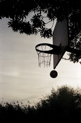 a basketball going through the hoop of a basketball court