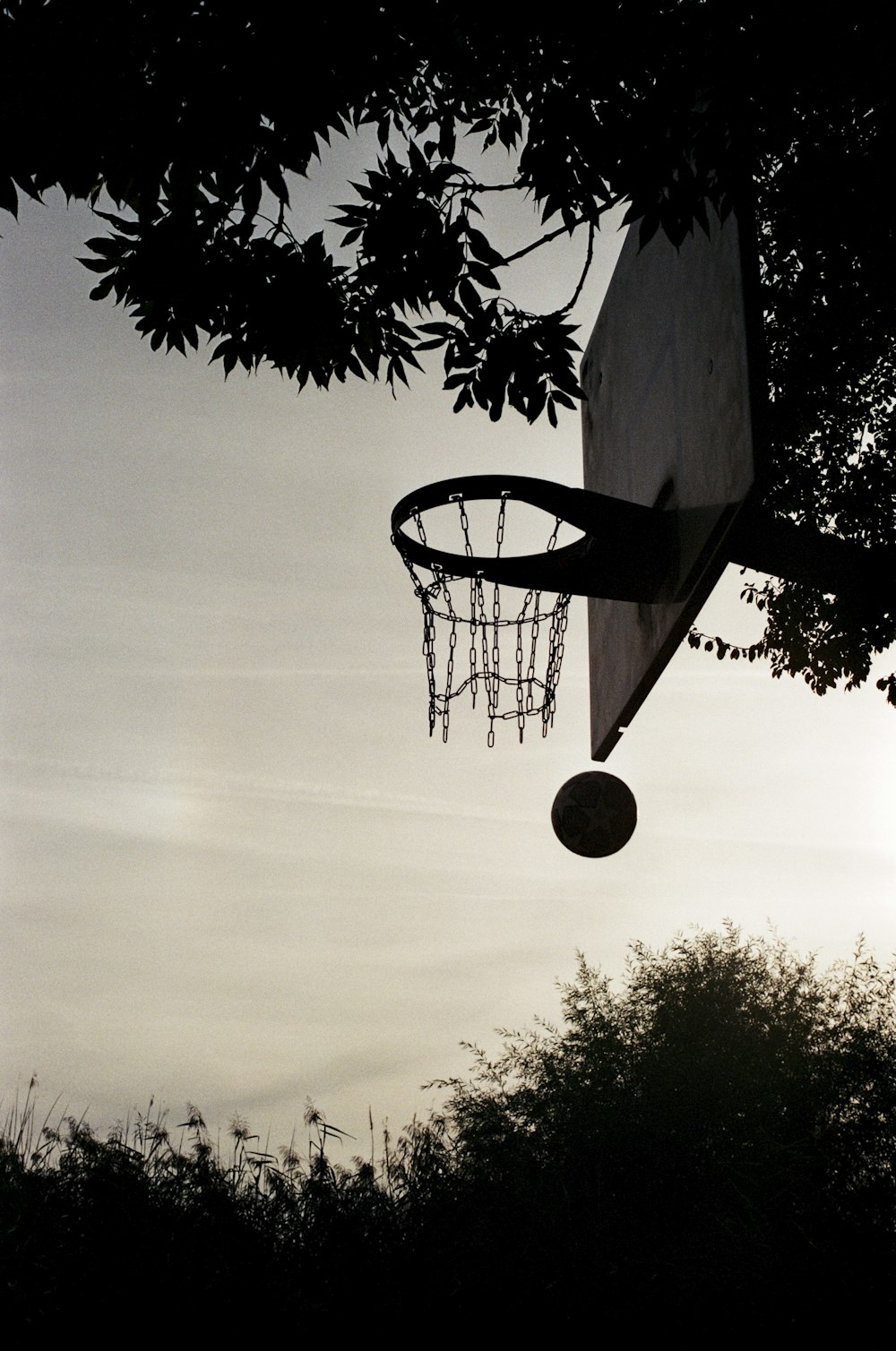 a basketball going through the hoop of a basketball court