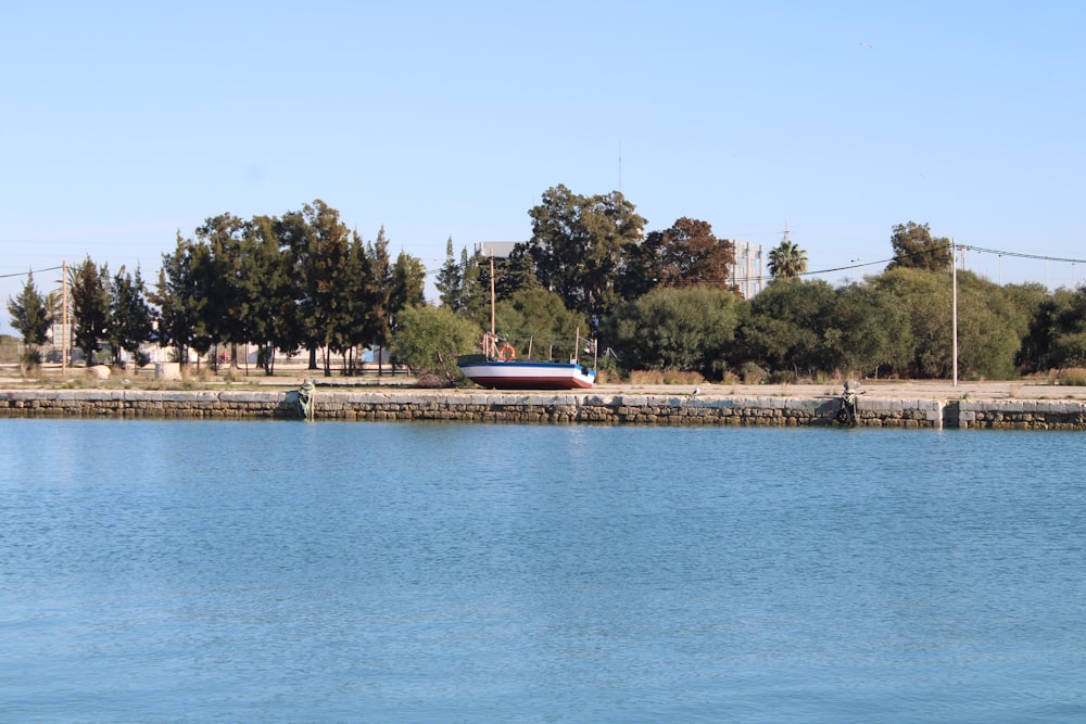 a large body of water with a boat in the distance