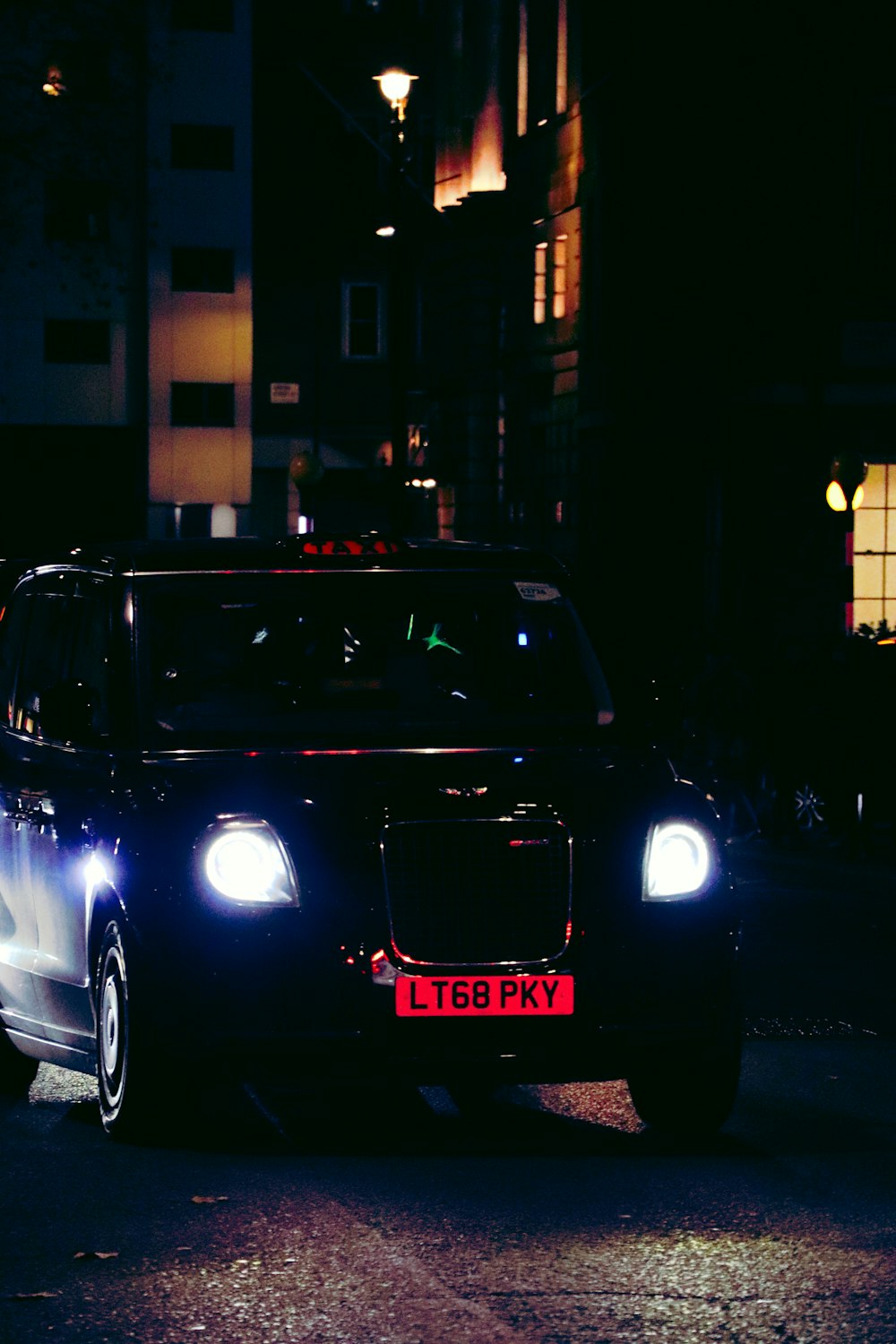 a car parked on the side of the road at night