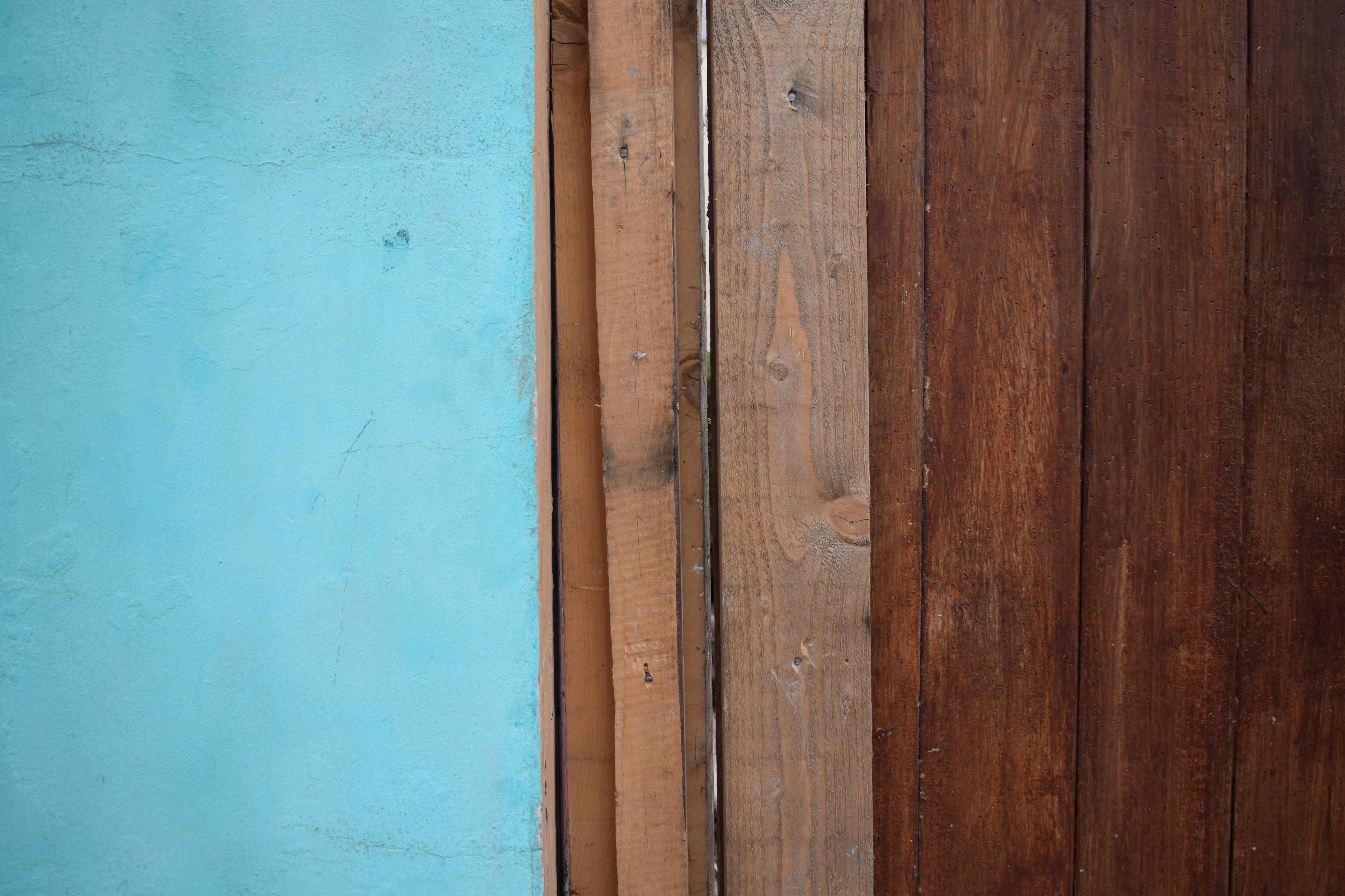 a blue wall and a wooden fence