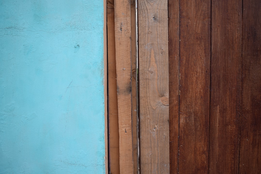 a blue wall and a wooden fence