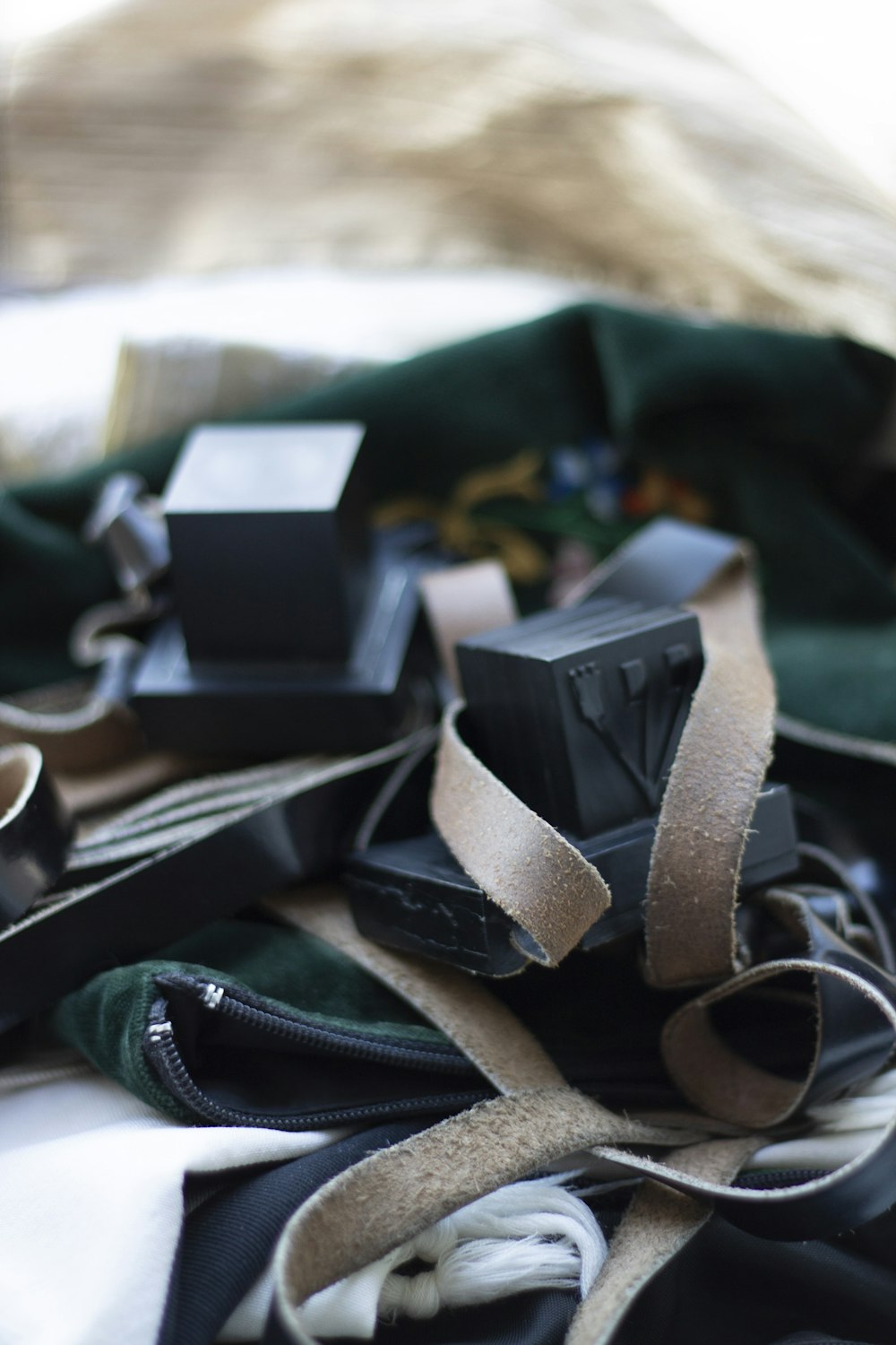 a pile of black and white items on a bed