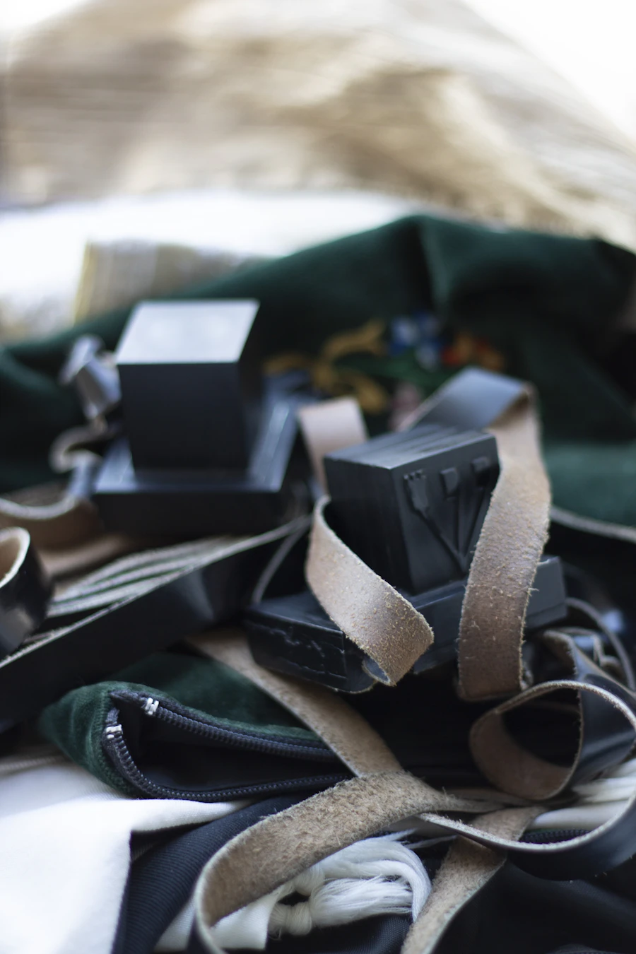 Folded tallit and tefillin laid out on white fabric