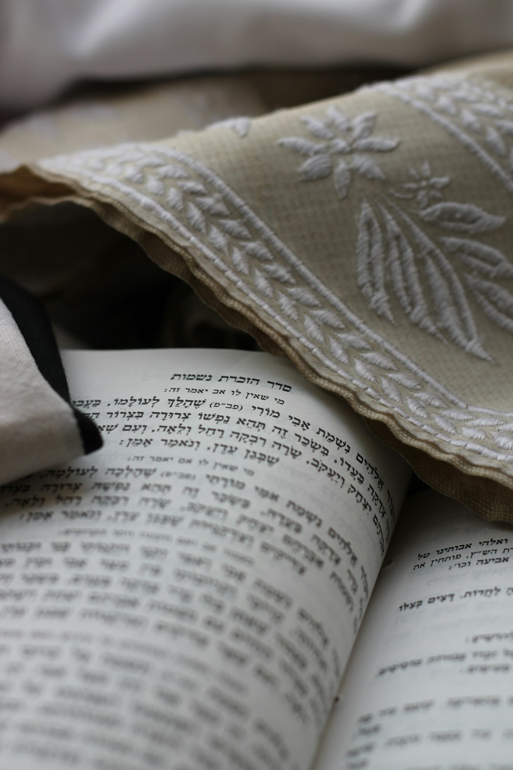 a close up of an open book on a bed