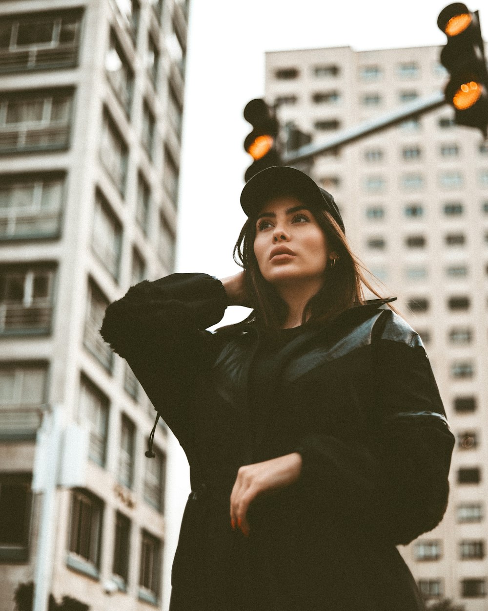 a woman standing in front of a traffic light