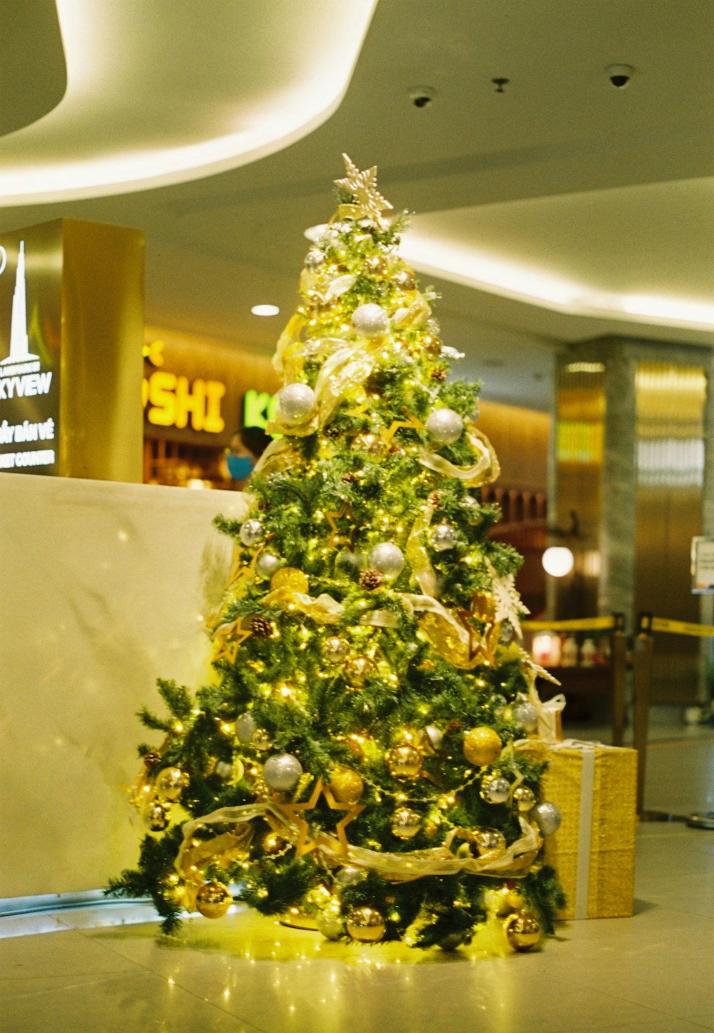 a decorated christmas tree in an airport lobby