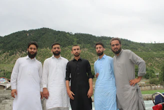 A group photo of the Kausachun movement leaders standing proudly with the provincial landscape behind them.