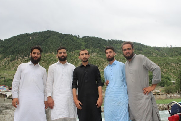 A group of Brothers of the Covenant Lodge 5 members gathered outside the Stone Mountain lodge building on a sunny day.