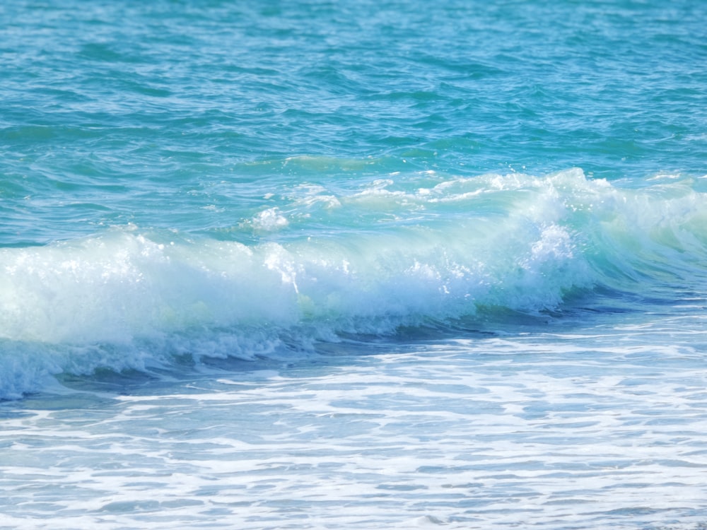 a man riding a wave on top of a surfboard