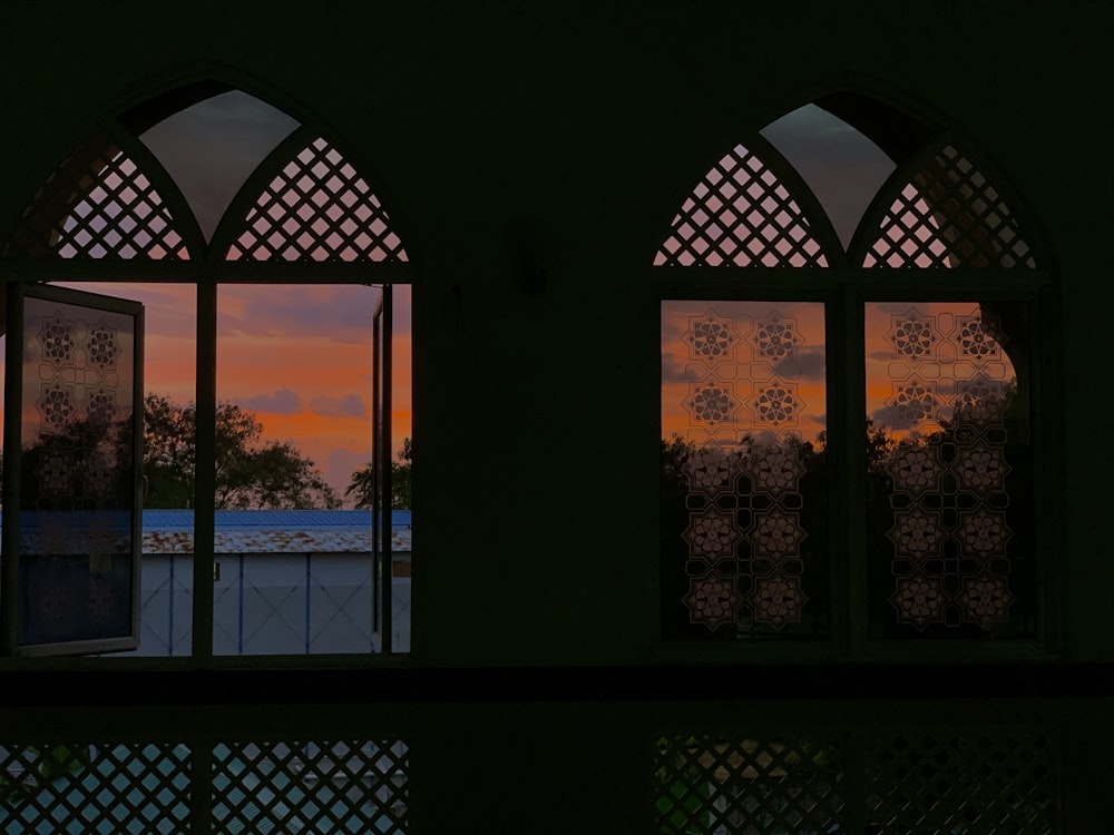 a view of a sunset through two windows