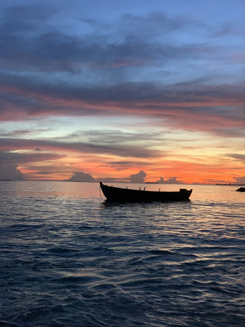 a boat floating on top of a large body of water