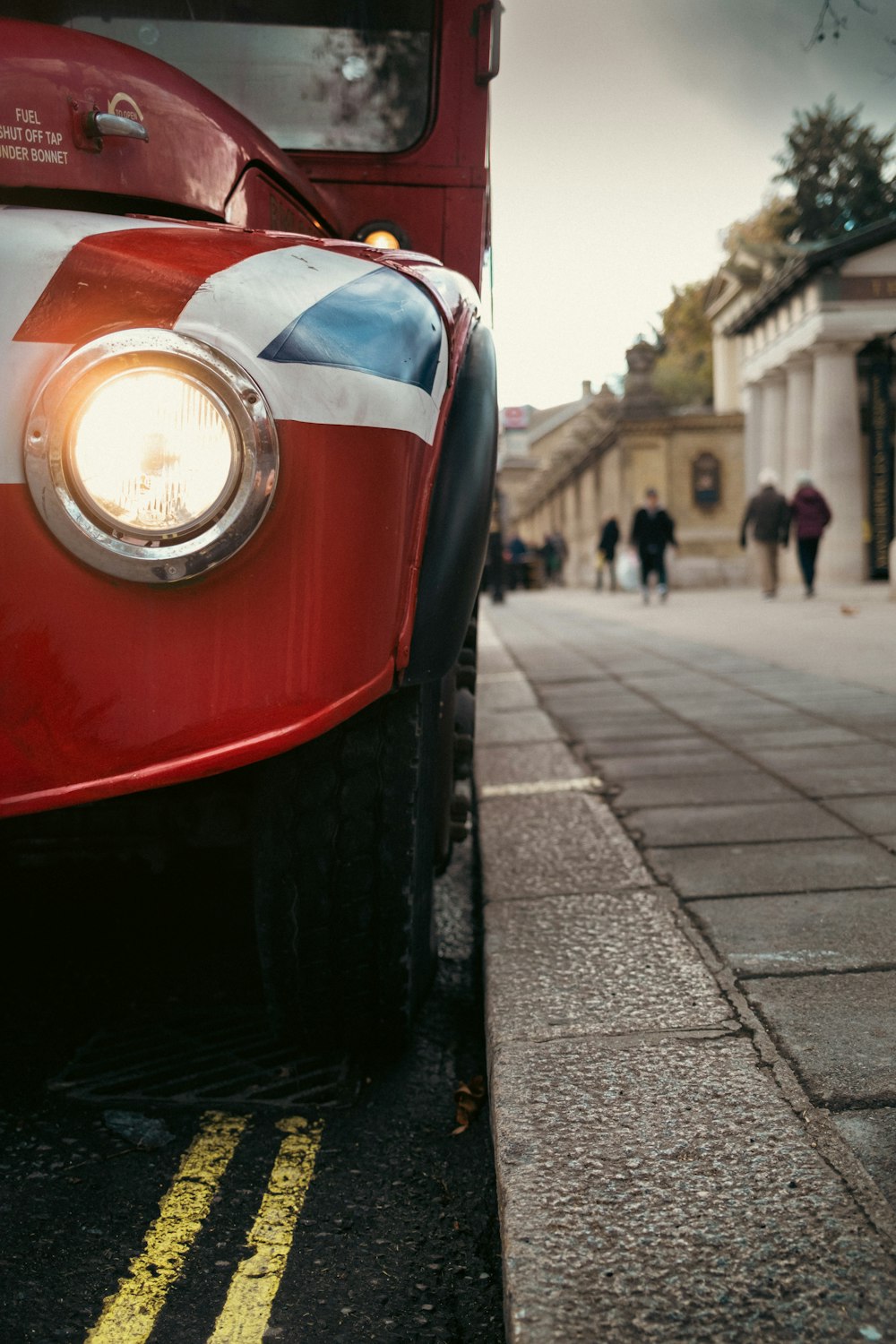 a red bus parked on the side of the road