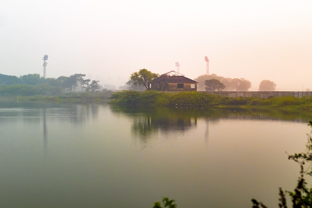 a body of water with a house in the distance