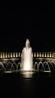 Technological setup behind a fountain showcasing pumps and lighting control systems.