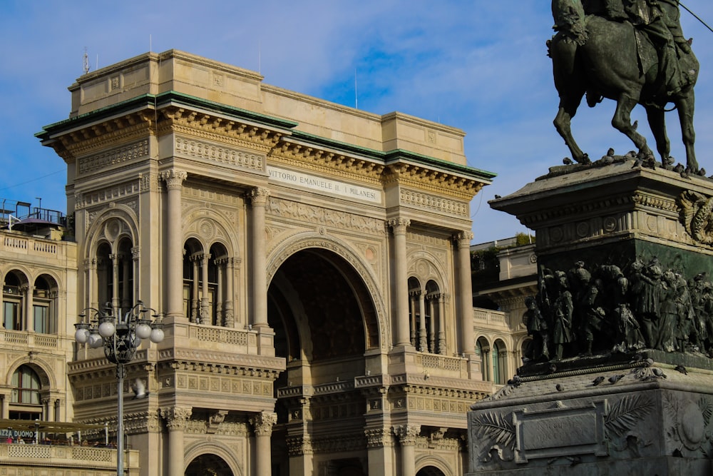 a statue of a man on a horse in front of a building