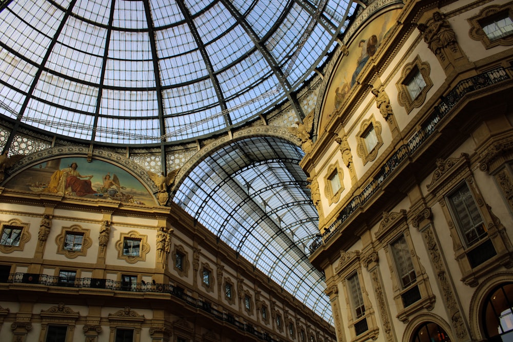 a glass ceiling in a building with a painting on it