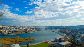 a view of a city and a river from a hill