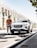 a man standing next to a white car