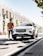a man standing next to a white car
