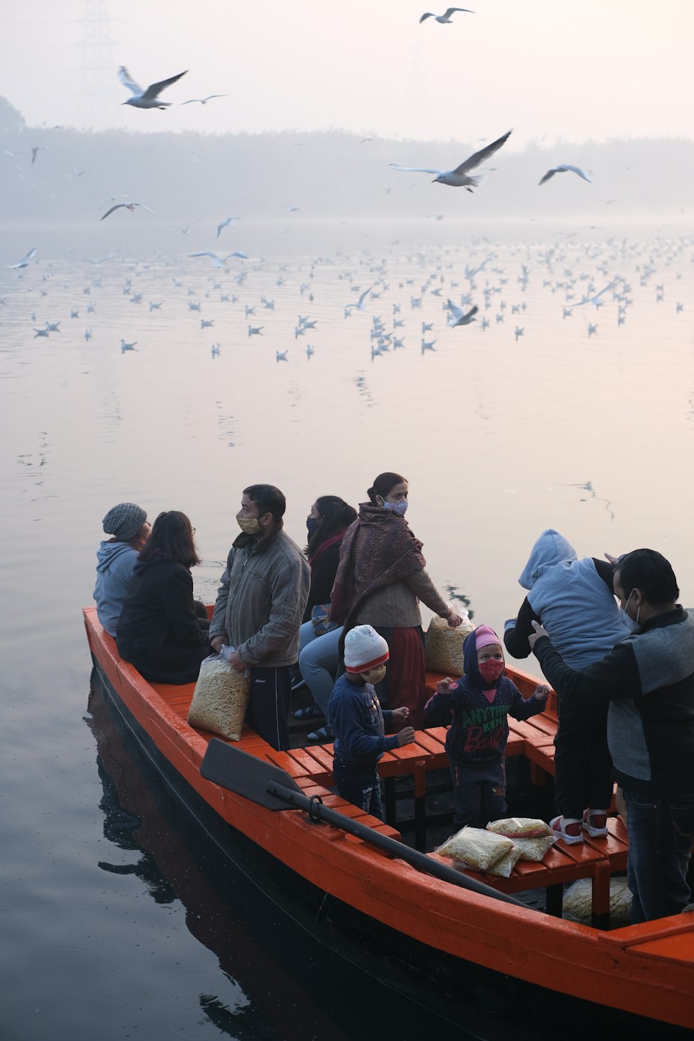 a group of people in a boat on the water