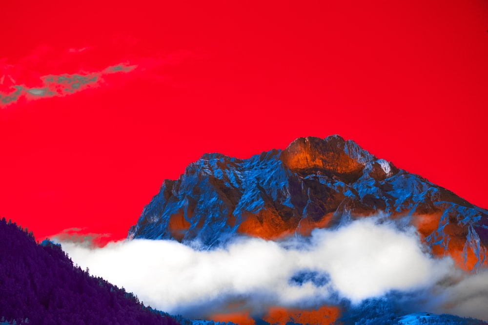 a painting of a mountain with a red sky in the background