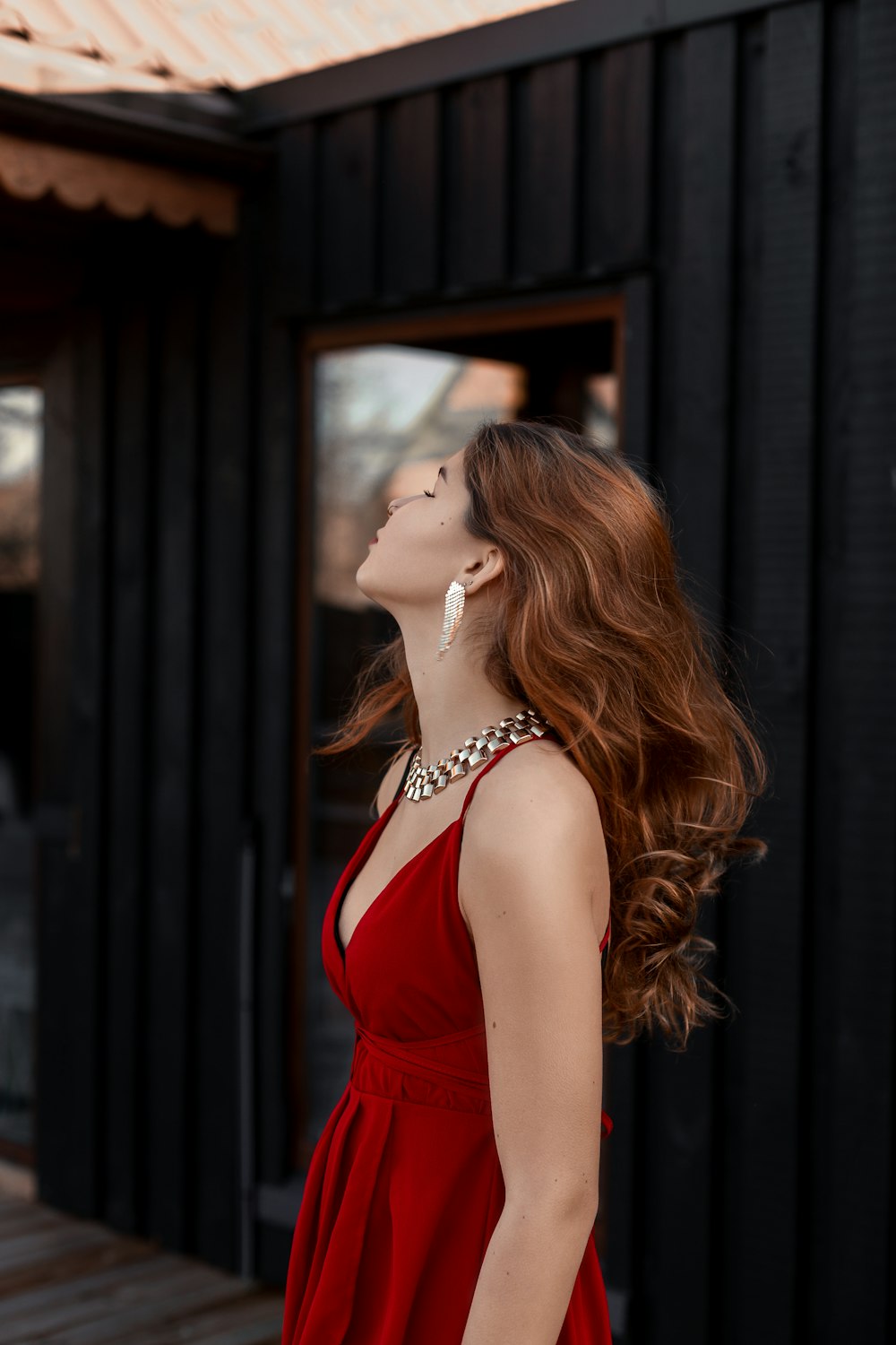 a woman in a red dress looking up