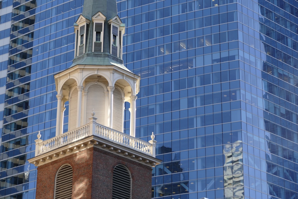 a tall building with a clock tower in front of it