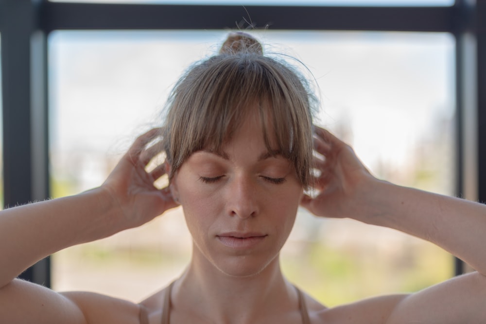 a woman with her hands on her head