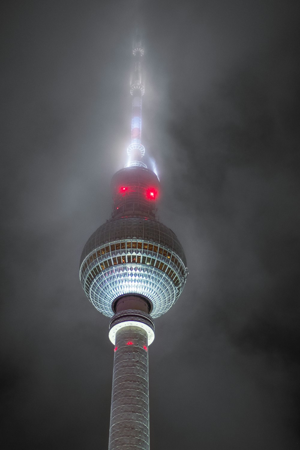 a tall tower with a red light on top of it