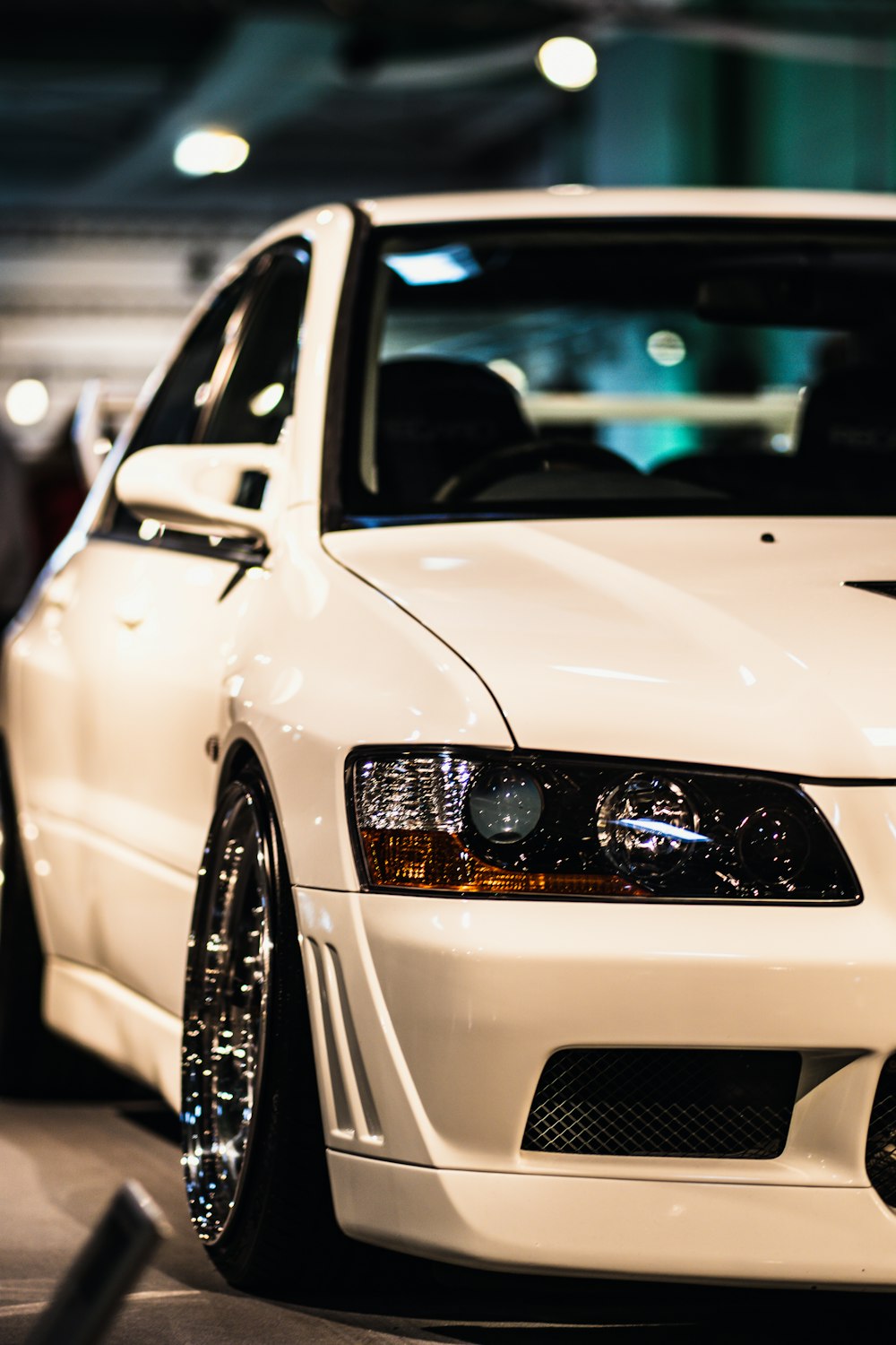 a white car parked in a parking garage