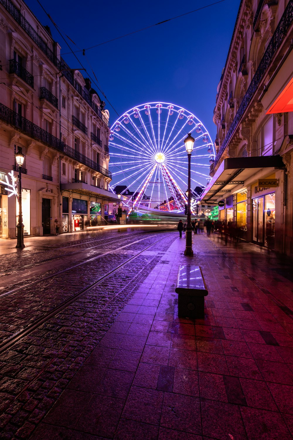 a ferris wheel in a city at night