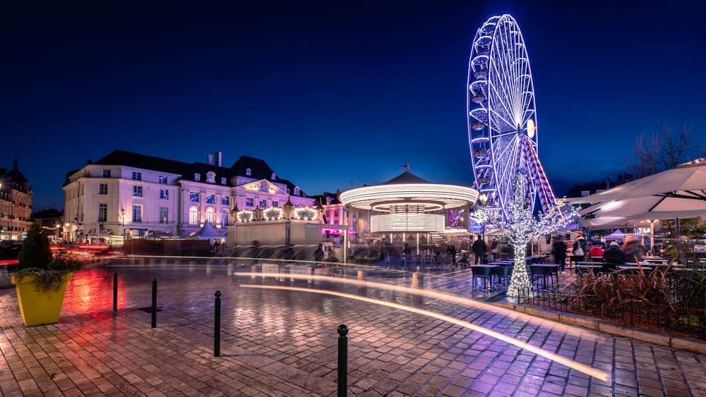 a ferris wheel is lit up at night