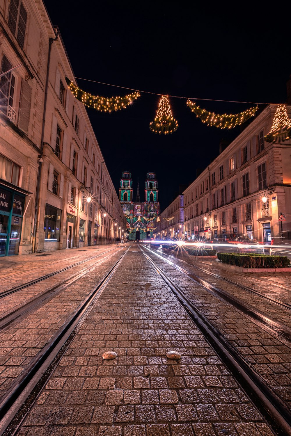 a city street at night with christmas lights