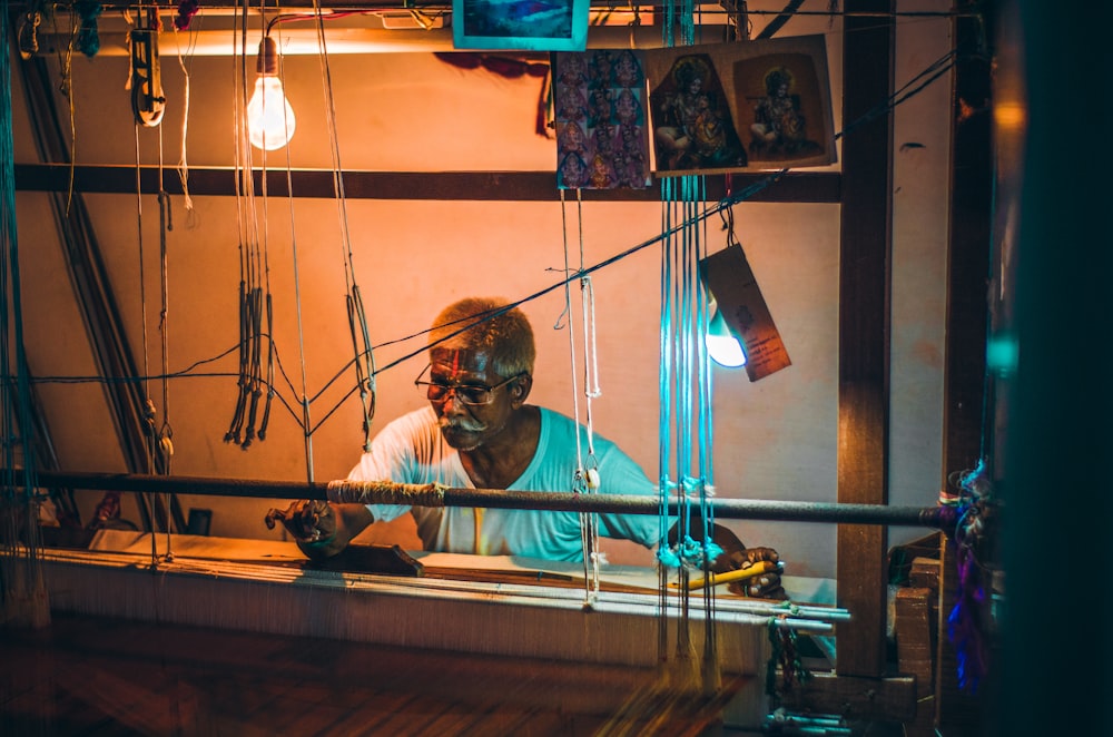 a man sitting at a table working on a computer