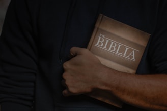 a man holding a bible in his hands