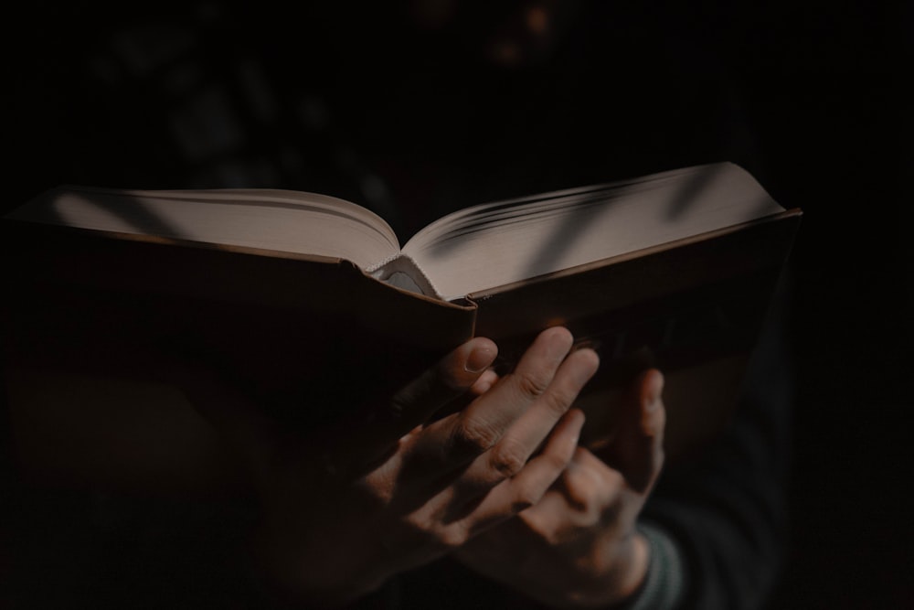 a person holding a book in their hands