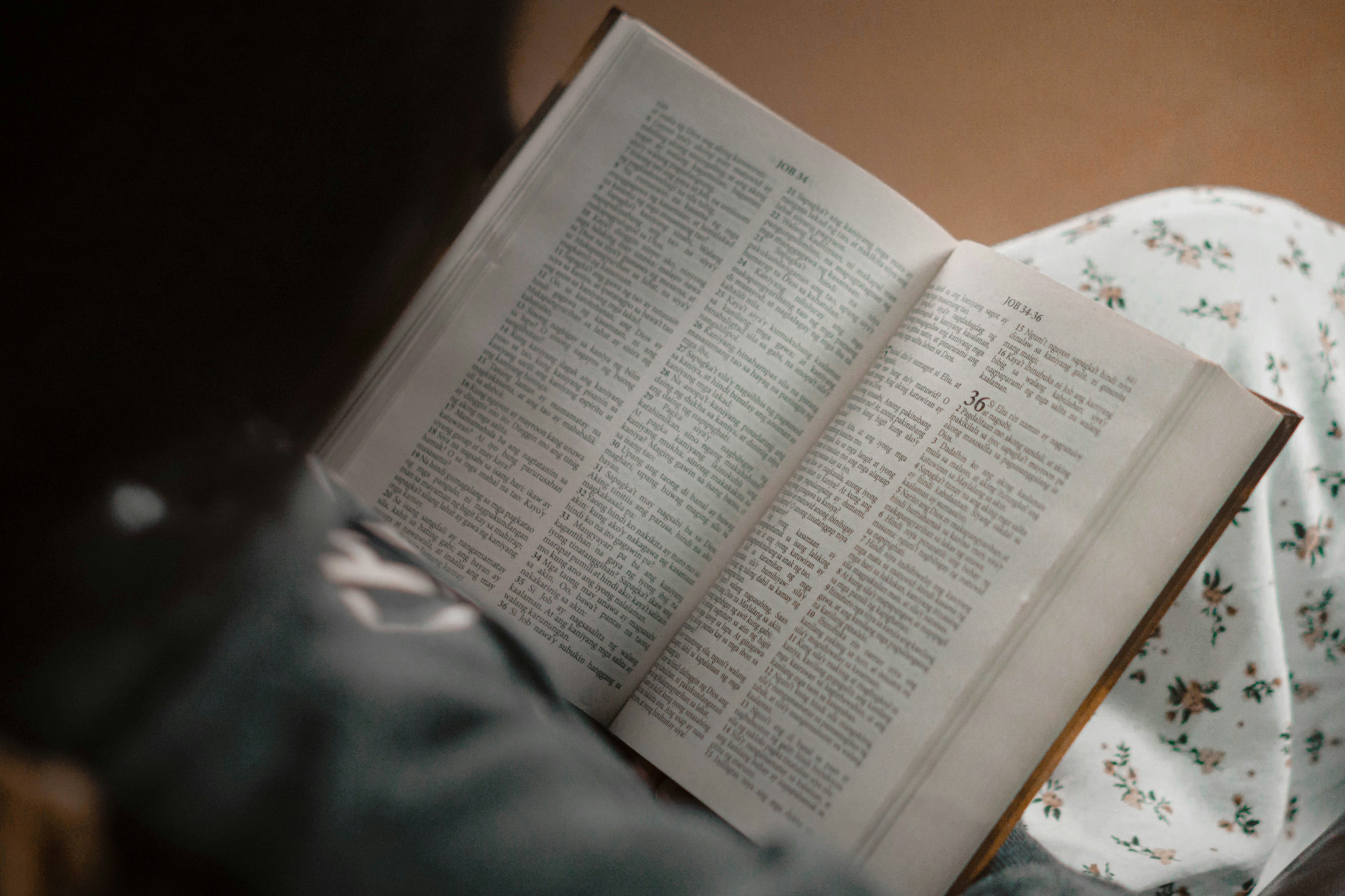 an open book sitting on top of a bed