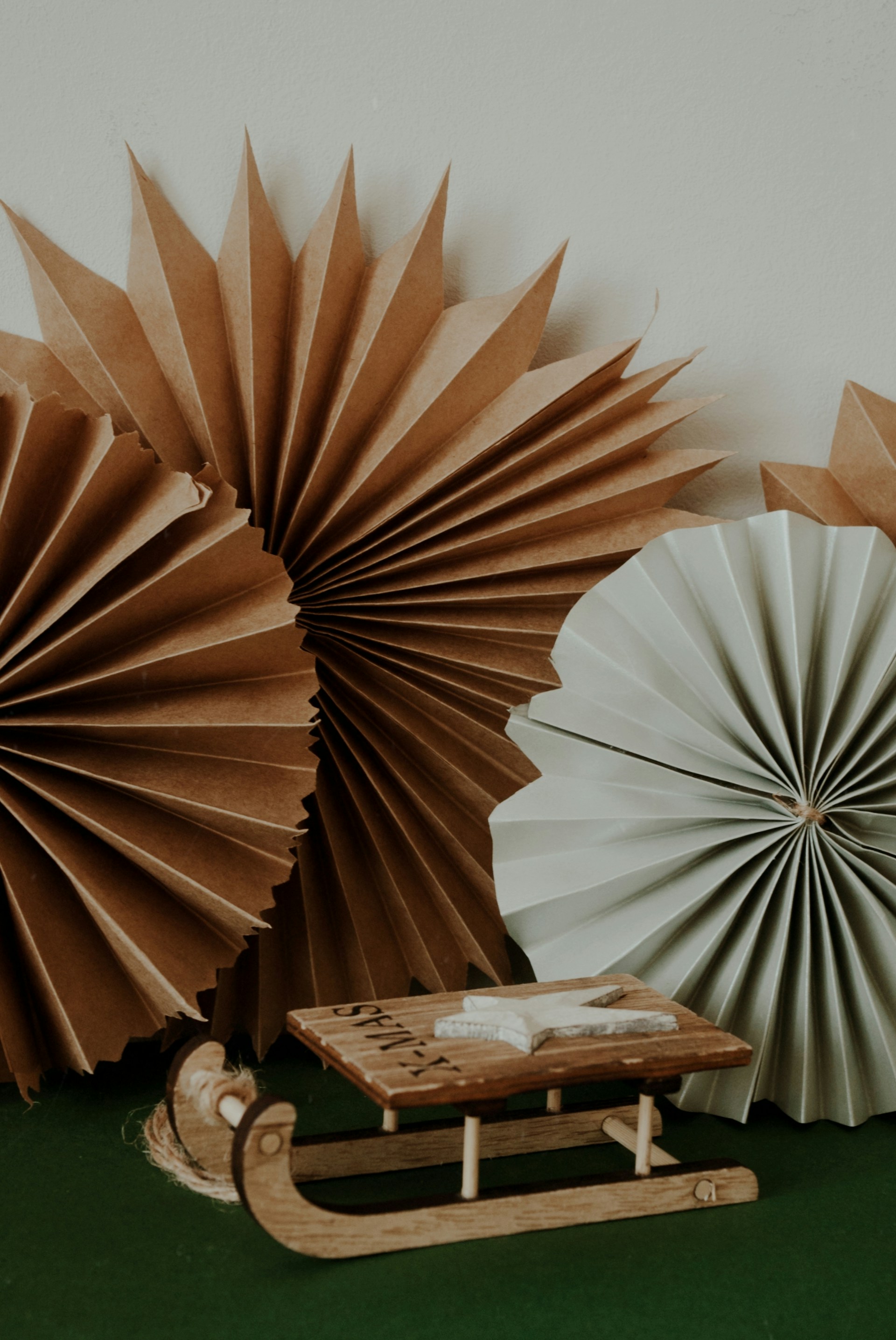 a group of paper fans sitting on top of a green floor
