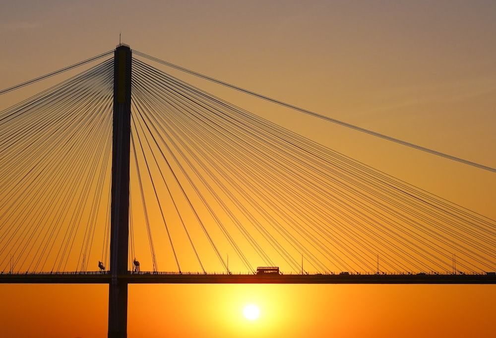 a large bridge lit up at sunset